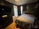 Serene bedroom with a double bed, dark walls, and hardwood floors at 604 Kimball St, Kannapolis, NC 28081