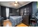 Bedroom with gray bedding, dresser, and gaming setup at 604 Kimball St, Kannapolis, NC 28081