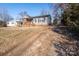 Gray siding house with brick base, wooden porch, and gravel driveway at 604 Kimball St, Kannapolis, NC 28081