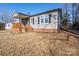 Gray siding house with brick base, wooden porch, and partially visible neighbor's house at 604 Kimball St, Kannapolis, NC 28081