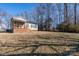 Gray siding house with brick base, wooden porch, and spacious backyard at 604 Kimball St, Kannapolis, NC 28081