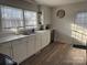 Bright kitchen featuring white cabinets, stainless steel appliances, and vinyl flooring at 604 Kimball St, Kannapolis, NC 28081