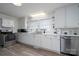 Bright kitchen with white cabinets, stainless steel appliances, and vinyl flooring at 604 Kimball St, Kannapolis, NC 28081