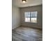 Well-lit bedroom featuring a large window and wood-look flooring at 6327 Honor Ave, Midland, NC 28107