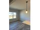 Bright, open living area featuring hardwood floors and a modern pendant light at 6327 Honor Ave, Midland, NC 28107