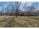 Large backyard with bare trees providing ample shade and privacy on a sunny day at 7753 Old Post Rd, Denver, NC 28037