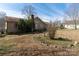 Backyard featuring a brick chimney and landscaping elements, offering a serene outdoor space at 7753 Old Post Rd, Denver, NC 28037