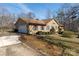 Tan home with a two car garage, neutral shutters, and a concrete driveway on a sunny day at 7753 Old Post Rd, Denver, NC 28037