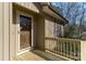 Front porch featuring wood flooring and a glass front door at 7753 Old Post Rd, Denver, NC 28037