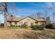 Charming single story home with brown siding, shutters, a well-manicured lawn, and mature trees at 7753 Old Post Rd, Denver, NC 28037