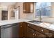 An updated kitchen with stainless steel appliances, white counters, and wood cabinets at 7753 Old Post Rd, Denver, NC 28037