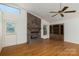 Living room featuring wood floors, a brick fireplace, and built-in cabinets at 7753 Old Post Rd, Denver, NC 28037