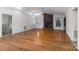 Open concept living room with hardwood floors, a brick fireplace, and lots of natural light at 7753 Old Post Rd, Denver, NC 28037