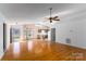 Spacious living room showcasing wood floors, high ceilings, and an open floor plan leading into the kitchen at 7753 Old Post Rd, Denver, NC 28037