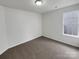 Simple bedroom with gray carpeting and a window at 811 Reigate Rd, Charlotte, NC 28262