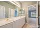 Bright bathroom boasts double sinks and vanity at 8355 Olde Troon Dr, Charlotte, NC 28277