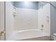 Clean bathroom with an oval bathtub and shower at 8355 Olde Troon Dr, Charlotte, NC 28277