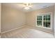 Spacious bedroom with large window and ceiling fan at 8355 Olde Troon Dr, Charlotte, NC 28277