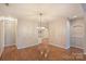 Spacious dining room with hardwood floors and chandelier at 8355 Olde Troon Dr, Charlotte, NC 28277