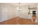 Bright dining room adjacent to kitchen, hardwood floors at 8355 Olde Troon Dr, Charlotte, NC 28277