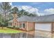 Brick ranch home with attached garage and landscaped yard at 8355 Olde Troon Dr, Charlotte, NC 28277