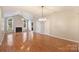 Open concept living and dining area with hardwood floors and fireplace at 8355 Olde Troon Dr, Charlotte, NC 28277