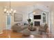 Bright living room featuring vaulted ceilings, a cozy fireplace, and natural light from large arched windows at 8355 Olde Troon Dr, Charlotte, NC 28277