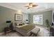 Serene main bedroom featuring tray ceiling, plush carpeting, and a large window with plantation blinds at 8355 Olde Troon Dr, Charlotte, NC 28277