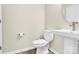 Small powder room with pedestal sink and toilet at 9131 Nw Harwen Ne Ln # 32, Charlotte, NC 28215