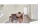 Dining area featuring a wood table and four leather chairs, next to hallway at 9131 Nw Harwen Ne Ln # 32, Charlotte, NC 28215