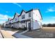 Modern townhome with white siding and a gray roof at 9131 Nw Harwen Ne Ln # 32, Charlotte, NC 28215