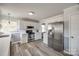 Kitchen with white cabinets, stainless steel appliances, and wood-look flooring at 100 Sea Island Blvd, Fort Mill, SC 29708