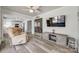 Bright living room with hardwood floors, ceiling fan, and view into kitchen at 100 Sea Island Blvd, Fort Mill, SC 29708