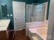 Bathroom with a shower and tub, double vanity, and separate toilet area at 1004 Rosewater Ln, Indian Trail, NC 28079