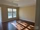 Bright bedroom with hardwood floors and two windows at 1004 Rosewater Ln, Indian Trail, NC 28079