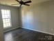 Well-lit bedroom featuring dark hardwood floors and a ceiling fan at 1004 Rosewater Ln, Indian Trail, NC 28079