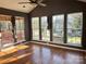 Sunroom with multiple windows, hardwood floors, and ceiling fan at 1004 Rosewater Ln, Indian Trail, NC 28079