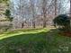 Large backyard with playset and wooded area at 10718 Lederer Ave, Charlotte, NC 28277