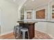 Basement wet bar with granite countertop and brick feature wall at 10718 Lederer Ave, Charlotte, NC 28277