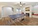 Basement recreation area with ping pong table and fireplace at 10718 Lederer Ave, Charlotte, NC 28277