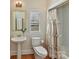 Small bathroom with pedestal sink, toilet and shower/tub combo at 10718 Lederer Ave, Charlotte, NC 28277