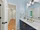 Light blue bathroom with vanity and hallway view at 10718 Lederer Ave, Charlotte, NC 28277