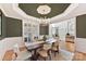 Elegant dining room with dark green walls and a large chandelier at 10718 Lederer Ave, Charlotte, NC 28277