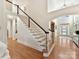 Two-story entryway with hardwood floors and elegant staircase at 10718 Lederer Ave, Charlotte, NC 28277