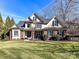 Brick two-story home with a large front yard and mature trees at 10718 Lederer Ave, Charlotte, NC 28277