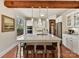 White kitchen with island, stainless steel appliances, and hardwood floors at 10718 Lederer Ave, Charlotte, NC 28277