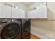 Laundry room with washer, dryer, and ample cabinet space at 10718 Lederer Ave, Charlotte, NC 28277