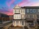 Two-story townhome with brick and siding exterior, featuring a charming front porch at 11043 Lawyers Rd # 32, Mint Hill, NC 28227