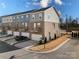 Rear view of townhome showcasing attached garage and private backyard space at 11043 Lawyers Rd # 32, Mint Hill, NC 28227