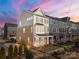 Two-story townhome with brick and siding exterior, showcasing a landscaped front yard at 11043 Lawyers Rd, Mint Hill, NC 28227